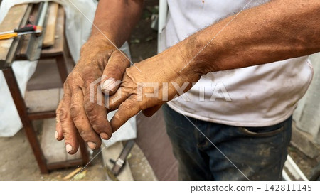 Close up of male dirty hands of adult labor at construction. Repairman rubbing unclean arms after hard work at the site. Concept of exhausting and hard work. Slow motion Close up of male dirty hands of adult labor at construction. Repairman rubbing unclean arms after hard work at the site. Concept of exhausting and hard work. Slow motion 142811145