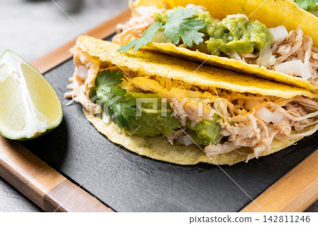 Mexican chicken tacos with guacamole and cilantro Mexican chicken tacos with guacamole and cilantro 142811246