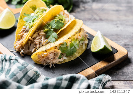 Mexican chicken tacos with guacamole and cilantro Mexican chicken tacos with guacamole and cilantro 142811247