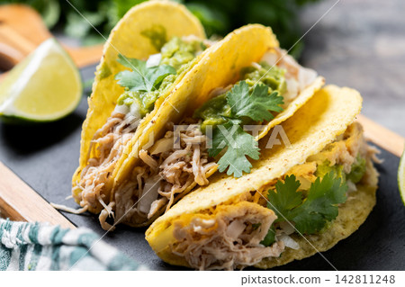 Mexican chicken tacos with guacamole and cilantro Mexican chicken tacos with guacamole and cilantro 142811248