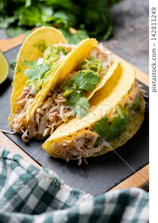 Mexican chicken tacos with guacamole and cilantro Mexican chicken tacos with guacamole and cilantro 142811249