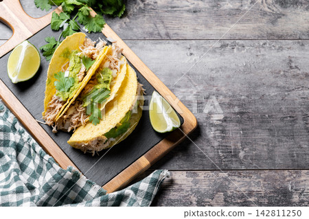 Mexican chicken tacos with guacamole and cilantro Mexican chicken tacos with guacamole and cilantro 142811250