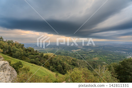 Layers of green mountains and hills in the haze during sunset. Panoramic View of Green hills and Meadow. 142811331