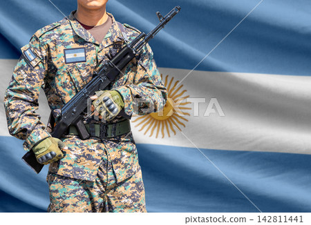 Argentina flag with soldier holding assault rifle Argentina flag with soldier holding assault rifle 142811441