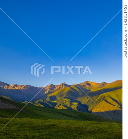 Mountain landscape with rolling hills and blue sky at sunrise Mountain landscape with rolling hills and blue sky at sunrise 142811455