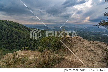 View of the mountains and Kislovodsk from the observation decks of the Kislovodsk Park. Evening sunset over the mountains of Kislovodsk. View of the mountains and Kislovodsk from the observation decks of the Kislovodsk Park. Evening sunset over the mountains of Kislovodsk. 142811672