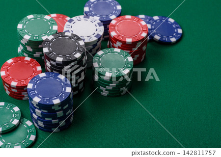Multi colored gaming chips for betting in casino games. Betting chips Multi colored gaming chips for betting in casino games. Betting chips 142811757