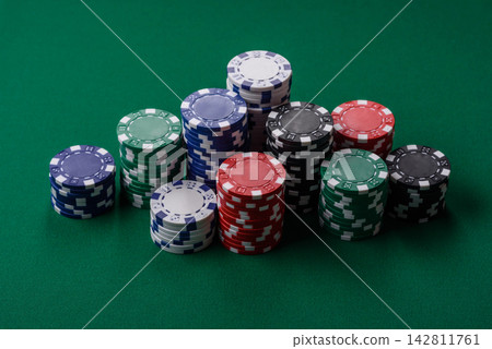 Multi colored gaming chips for betting in casino games. Betting chips Multi colored gaming chips for betting in casino games. Betting chips 142811761