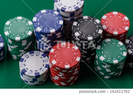 Multi colored gaming chips for betting in casino games. Betting chips Multi colored gaming chips for betting in casino games. Betting chips 142811762