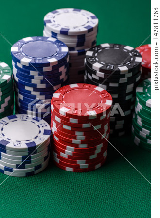 Multi colored gaming chips for betting in casino games. Betting chips 142811763