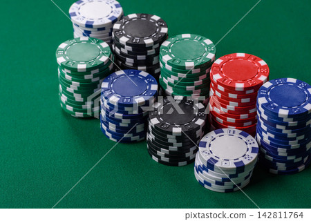 Multi colored gaming chips for betting in casino games. Betting chips 142811764