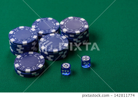 Multicolored casino chips as a conceptual backdrop for gambling games like poker, blackjack Multicolored casino chips as a conceptual backdrop for gambling games like poker, blackjack 142811774