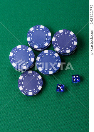Multicolored casino chips as a conceptual backdrop for gambling games like poker, blackjack 142811775