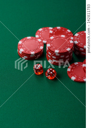 Multicolored casino chips as a conceptual backdrop for gambling games like poker, blackjack Multicolored casino chips as a conceptual backdrop for gambling games like poker, blackjack 142811783