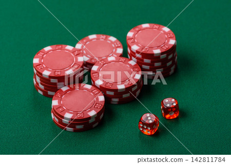 Multicolored casino chips as a conceptual backdrop for gambling games like poker, blackjack Multicolored casino chips as a conceptual backdrop for gambling games like poker, blackjack 142811784