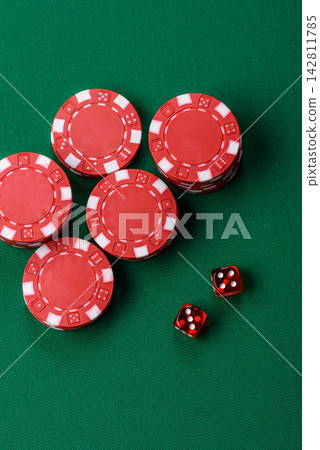 Multicolored casino chips as a conceptual backdrop for gambling games like poker, blackjack Multicolored casino chips as a conceptual backdrop for gambling games like poker, blackjack 142811785