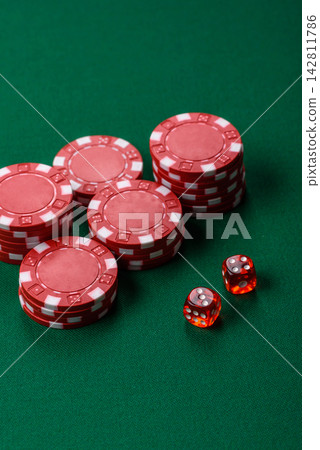 Multicolored casino chips as a conceptual backdrop for gambling games like poker, blackjack 142811786