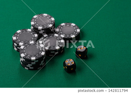 Multicolored casino chips as a conceptual backdrop for gambling games like poker, blackjack Multicolored casino chips as a conceptual backdrop for gambling games like poker, blackjack 142811794