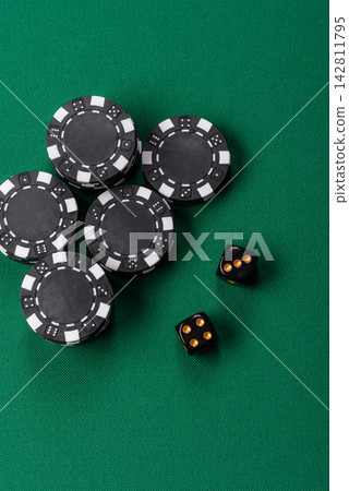 Multicolored casino chips as a conceptual backdrop for gambling games like poker, blackjack Multicolored casino chips as a conceptual backdrop for gambling games like poker, blackjack 142811795
