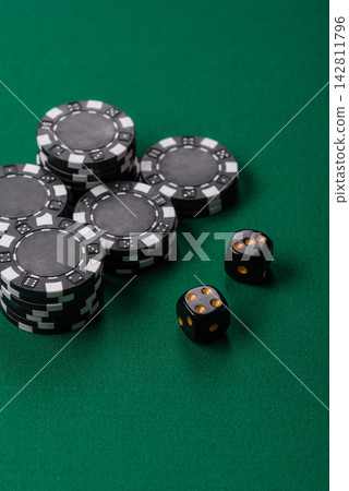 Multicolored casino chips as a conceptual backdrop for gambling games like poker, blackjack Multicolored casino chips as a conceptual backdrop for gambling games like poker, blackjack 142811796