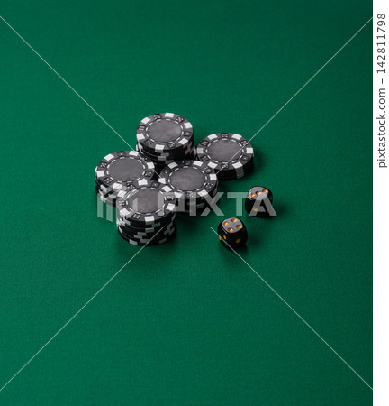 Multicolored casino chips as a conceptual backdrop for gambling games like poker, blackjack Multicolored casino chips as a conceptual backdrop for gambling games like poker, blackjack 142811798
