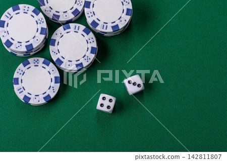 Multicolored casino chips as a conceptual backdrop for gambling games like poker, blackjack Multicolored casino chips as a conceptual backdrop for gambling games like poker, blackjack 142811807