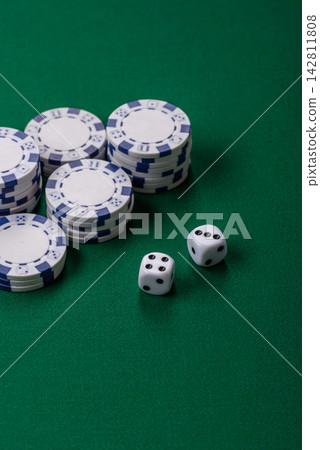 Multicolored casino chips as a conceptual backdrop for gambling games like poker, blackjack Multicolored casino chips as a conceptual backdrop for gambling games like poker, blackjack 142811808