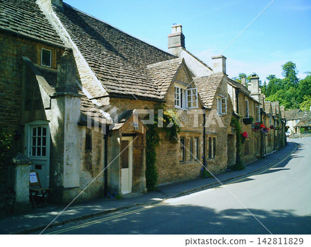 Castle Combe, a row of historic stone houses in the Cotswolds. Castle Combe, a row of historic stone houses in the Cotswolds. 142811829