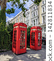 Red telephone boxes lined up on the streets of London 142811834