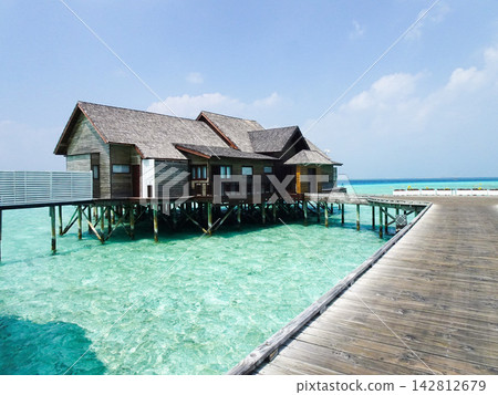 Water cottages and the blue sea Water cottages and the blue sea 142812679