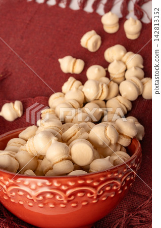Brazilian sweet meringue, a delicious dessert made of eggs and sugar called "suspiro" in a city in Minas Gerais, Brazil, selective focus. Brazilian sweet meringue, a delicious dessert made of eggs and sugar called "suspiro" in a city in Minas Gerais, Brazil, selective focus. 142813152