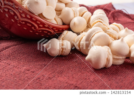 Brazilian sweet meringue, a delicious dessert made of eggs and sugar called "suspiro" in a city in Minas Gerais, Brazil, selective focus. 142813154
