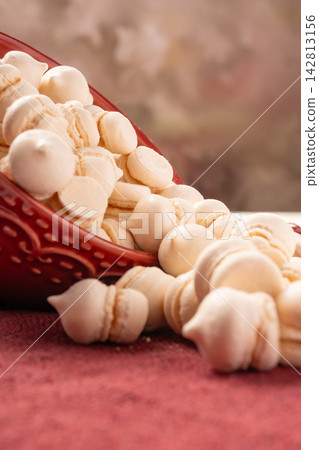 Brazilian sweet meringue, a delicious dessert made of eggs and sugar called "suspiro" in a city in Minas Gerais, Brazil, selective focus. Brazilian sweet meringue, a delicious dessert made of eggs and sugar called "suspiro" in a city in Minas Gerais, Brazil, selective focus. 142813156