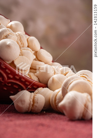 Brazilian sweet meringue, a delicious dessert made of eggs and sugar called "suspiro" in a city in Minas Gerais, Brazil, selective focus. Brazilian sweet meringue, a delicious dessert made of eggs and sugar called "suspiro" in a city in Minas Gerais, Brazil, selective focus. 142813159