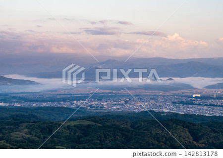 A sunrise scene shrouded in morning mist, photographed from the summit of Mt. Kamui. A sunrise scene shrouded in morning mist, photographed from the summit of Mt. Kamui. 142813178