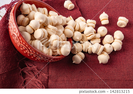 Brazilian sweet meringue, a delicious dessert made of eggs and sugar called "suspiro" in a city in Minas Gerais, Brazil, selective focus. 142813215