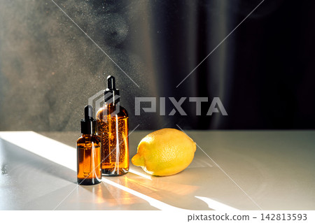 Essential oil dropper bottles with citrus lemon for aromatherapy Essential oil dropper bottles with citrus lemon for aromatherapy 142813593