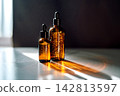 Amber glass skincare serum bottles with sunlight reflection 142813597