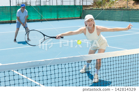 Senior woman plays tennis Senior woman plays tennis 142814329