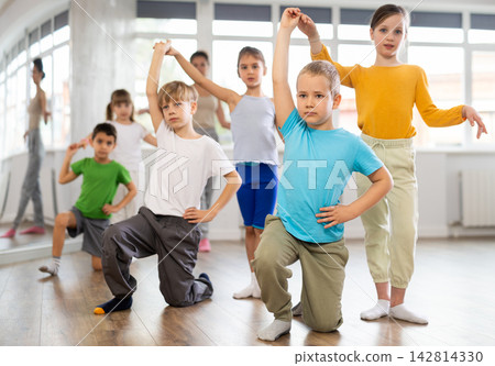 Girl paired up with boy, they train to perform slow waltz dance, rehearse performance. 142814330