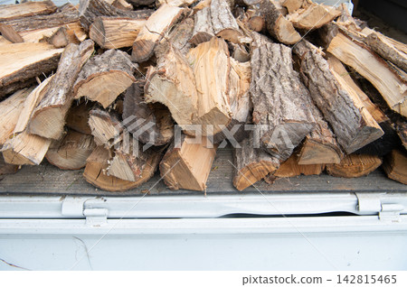 Firewood loaded onto a light truck Firewood loaded onto a light truck 142815465