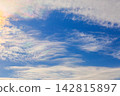 A blue sky with iridescent clouds. 142815897