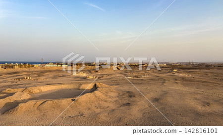 Panoramic view of desert landscape and coastal town Panoramic view of desert landscape and coastal town 142816101
