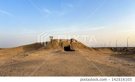Earthen military bunker embedded in a desert mound Earthen military bunker embedded in a desert mound 142816103