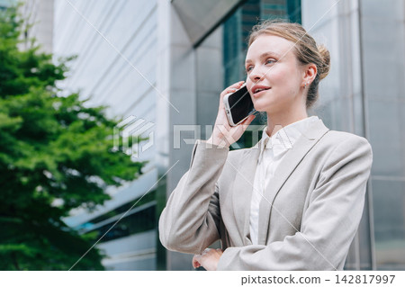Businesswoman using Phone calling business contact, Communicating technology with office people marketing deal. Businesswoman using Phone calling business contact, Communicating technology with office people marketing deal. 142817997