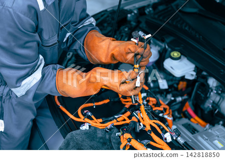 EV Auto Mechanic Technician Repairing Electric Car Engine Power line, High Voltage Cable Vehicle Garage Service EV Auto Mechanic Technician Repairing Electric Car Engine Power line, High Voltage Cable Vehicle Garage Service 142818850