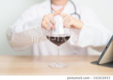 Doctor hand stop to refuse Wine, quitting drink for healthy liver, prevent Alcoholic cirrhosis and cancer, World No Alcohol Day, medical advice for sobriety and Alcoholism and addiction concept Doctor hand stop to refuse Wine, quitting drink for healthy liver, prevent Alcoholic cirrhosis and cancer, World No Alcohol Day, medical advice for sobriety and Alcoholism and addiction concept 142818915