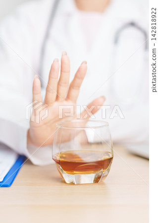 Doctor hand stop to refuse Whisky, quitting drink for healthy liver, prevent Alcoholic cirrhosis and cancer, World No Alcohol Day, medical advice for sobriety and Alcoholism and addiction concept 142818922