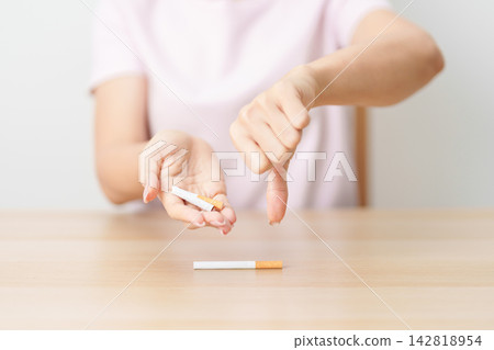 hand show thumb down to cigarette for World No Tobacco Day concept, quitting smoking to prevent Lung Cancer, COPD, Emphysema and Tuberculosis. healthy lifestyle resolution, stop nicotine addiction hand show thumb down to cigarette for World No Tobacco Day concept, quitting smoking to prevent Lung Cancer, COPD, Emphysema and Tuberculosis. healthy lifestyle resolution, stop nicotine addiction 142818954