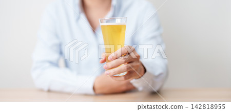 man with glass of Beer on table, suffering from alcohol addiction and alcoholism concept. depicting emotional distress, depression, substance abuse problem, unhealthy lifestyle and mental health man with glass of Beer on table, suffering from alcohol addiction and alcoholism concept. depicting emotional distress, depression, substance abuse problem, unhealthy lifestyle and mental health 142818955